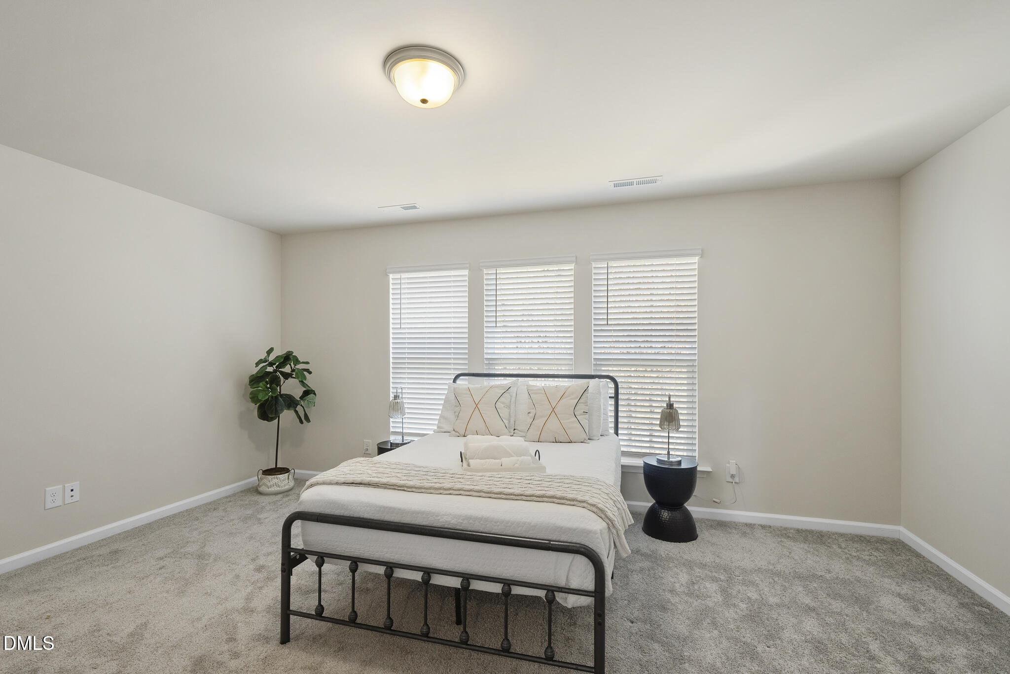 1012 Citadel Avenue Durham, NC 27713 - Photo 28 of 34 a bedroom with a bed and a potted plant