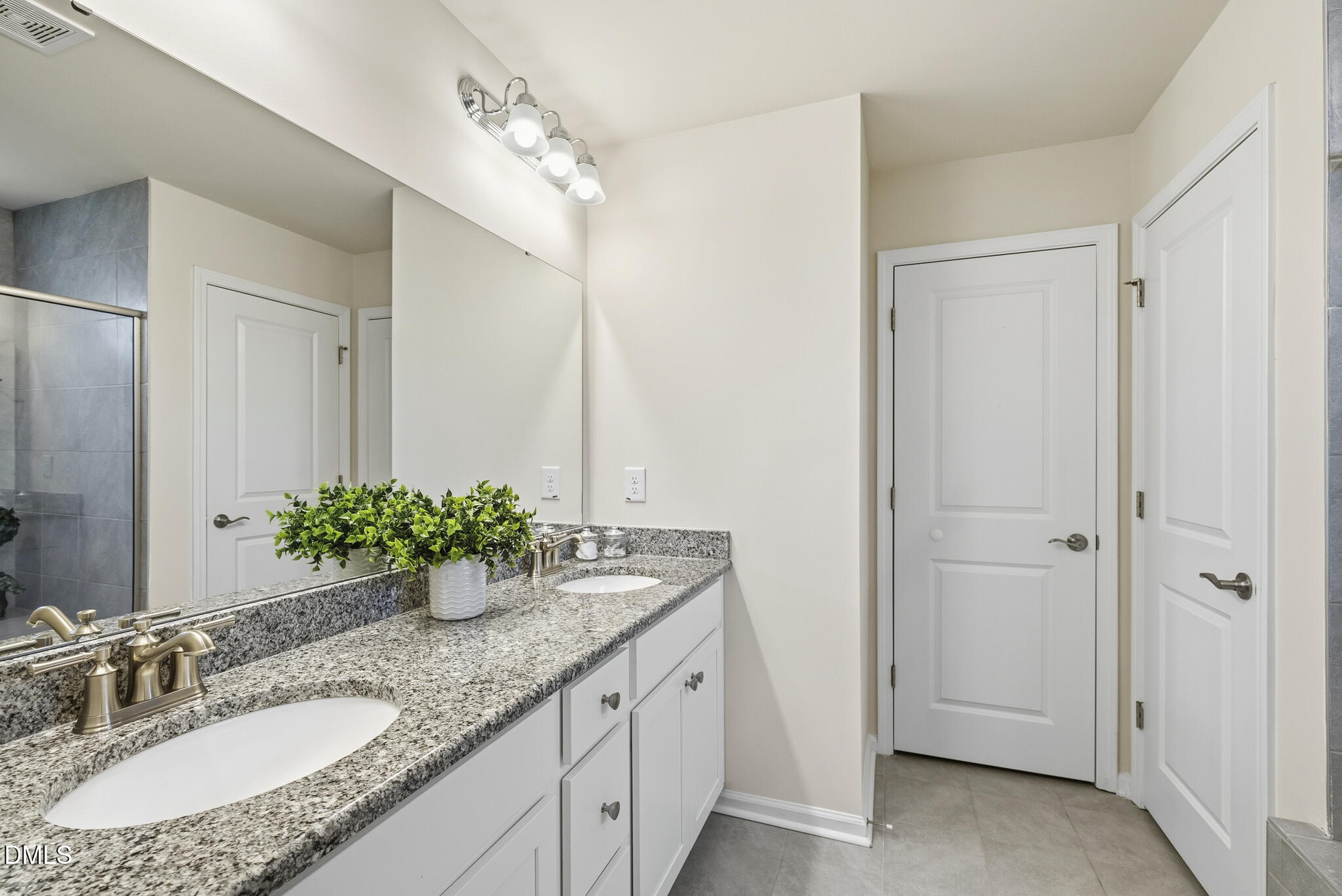 1012 Citadel Avenue Durham, NC 27713 - Photo 31 of 34 a bathroom with a granite countertop double vanity sink and a mirror