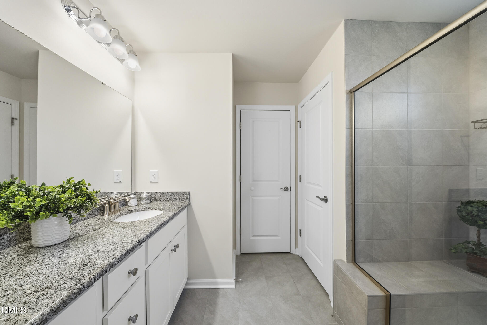1012 Citadel Avenue Durham, NC 27713 - Photo 32 of 34 a spacious bathroom with a granite countertop sink and a mirror