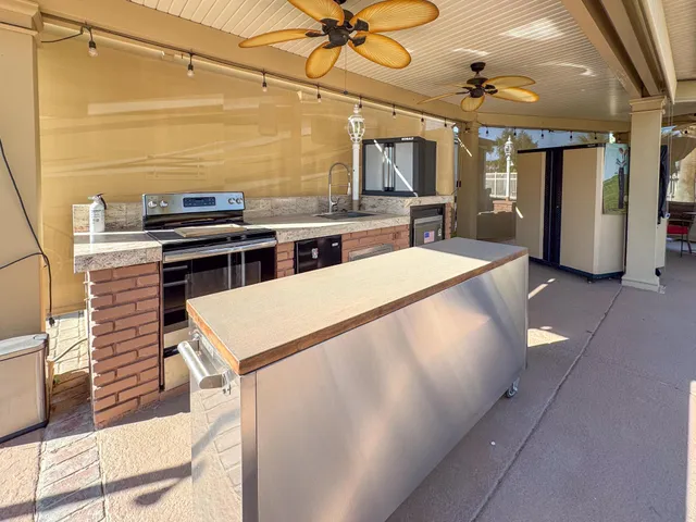 a kitchen with stainless steel appliances a stove a refrigerator and cabinets