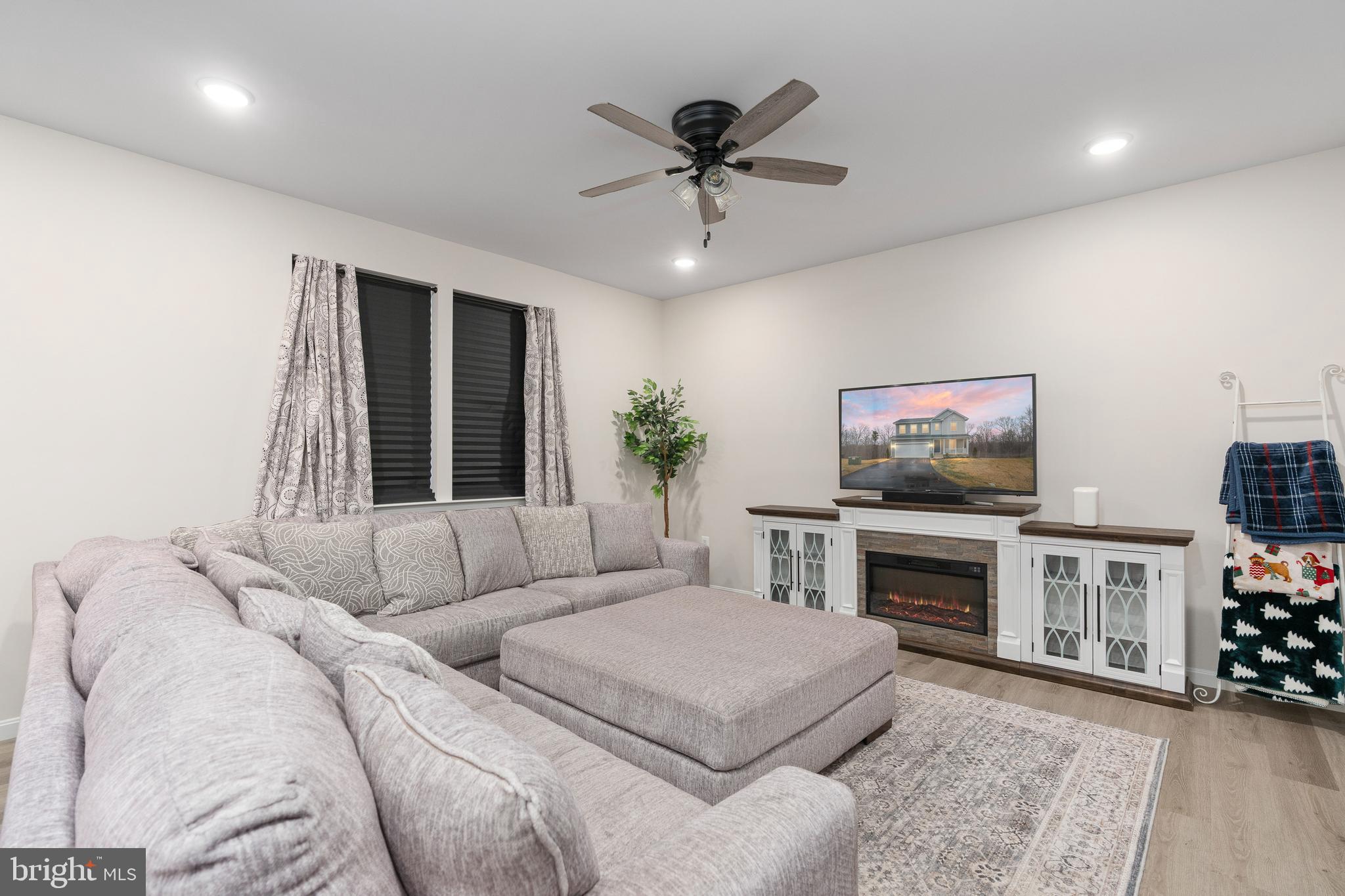 35514 Aspen Way Locust Grove, VA 22508 - Photo 19 of 56 a living room with furniture a fireplace and a flat screen tv