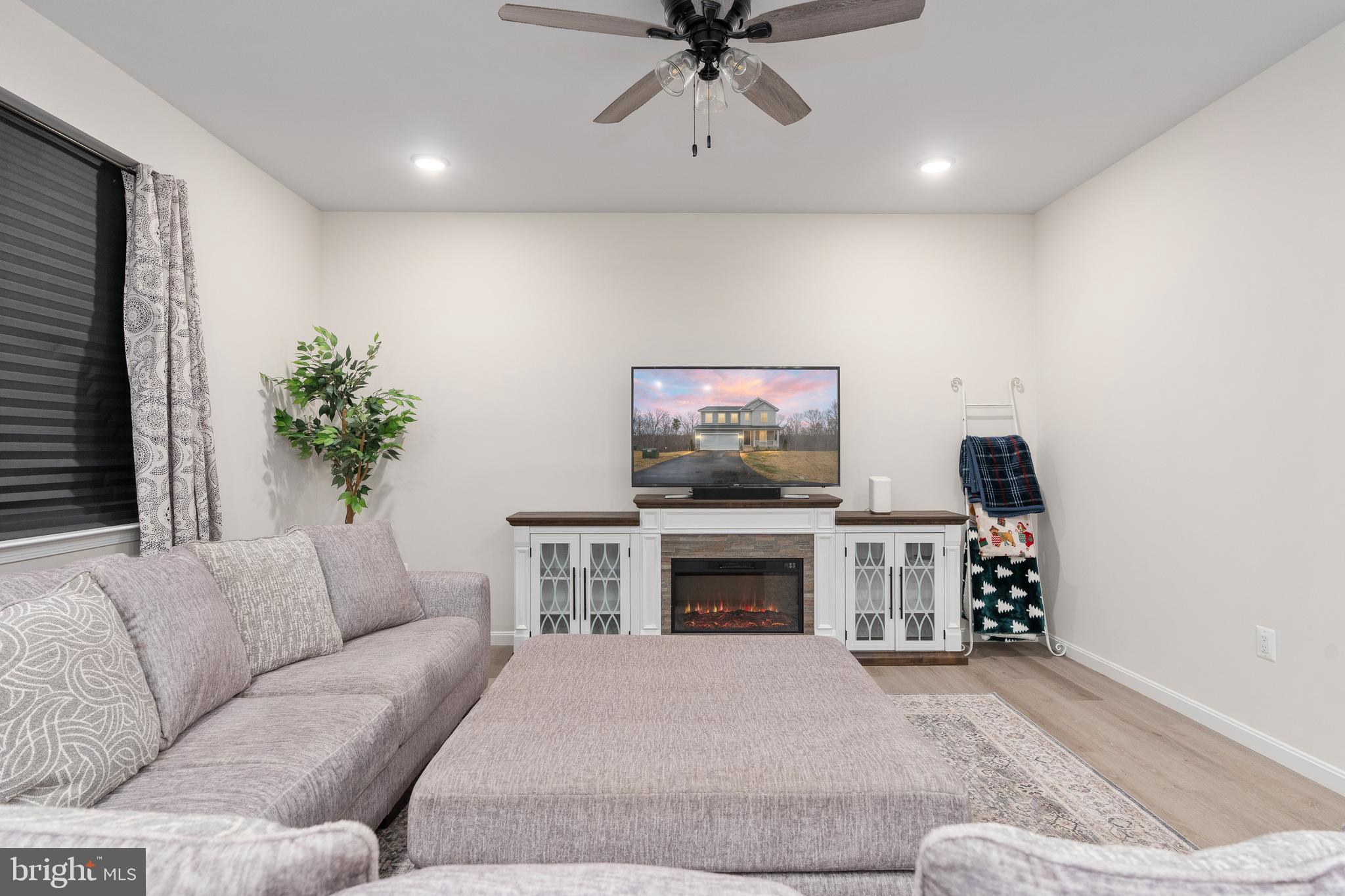 35514 Aspen Way Locust Grove, VA 22508 - Photo 22 of 56 a living room with furniture a fireplace and a flat screen tv