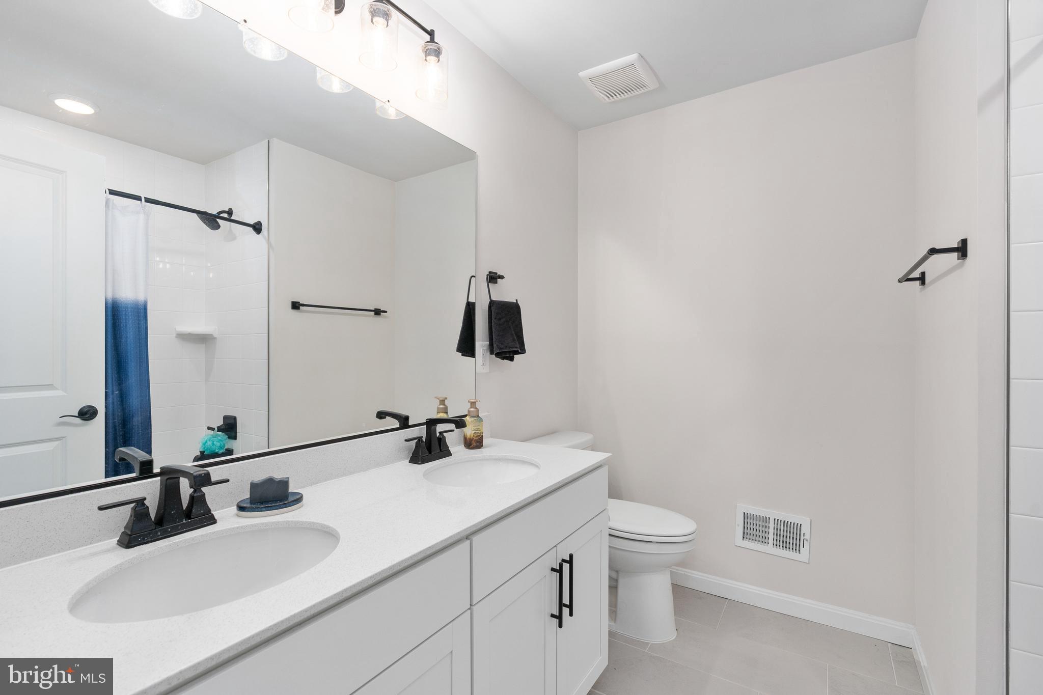 35514 Aspen Way Locust Grove, VA 22508 - Photo 29 of 56 a bathroom with a double vanity sink toilet and mirror