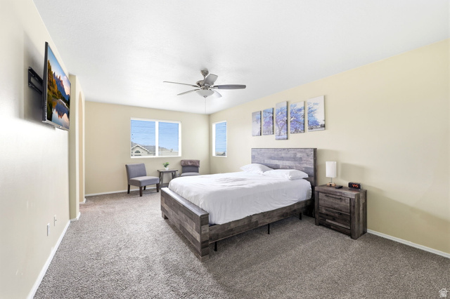 5485 Heather Way Tooele, UT 84074 - Photo 23 of 41 Spacious room featuring neutral wall tones, textured carpet flooring, and multiple windows