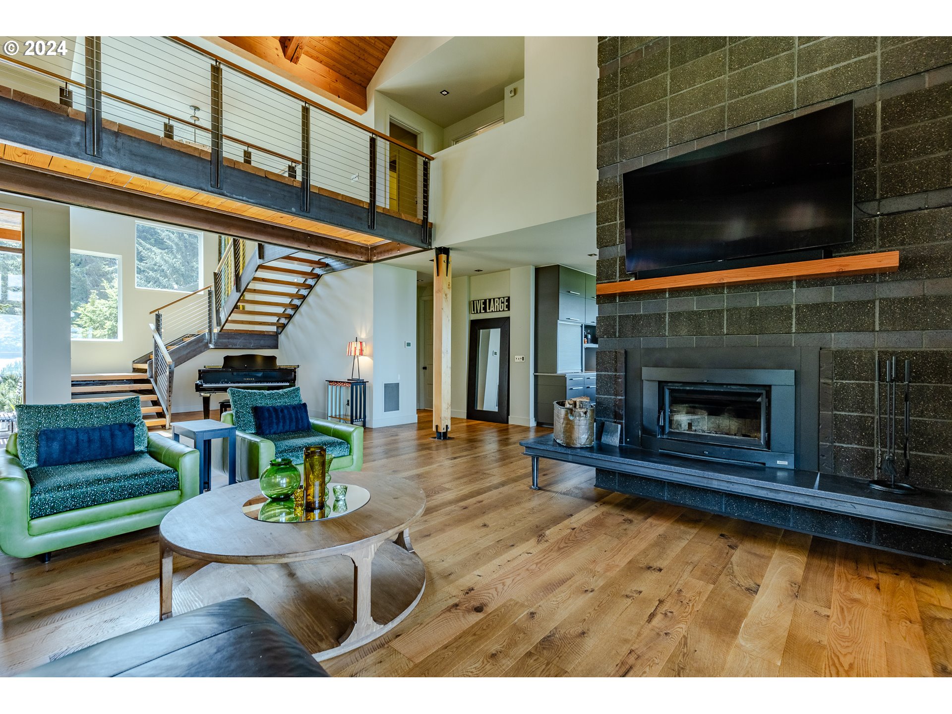 90535 Coburghills Drive Eugene, OR 97408 - Photo 11 of 48 a living room with furniture a flat screen tv and a fireplace