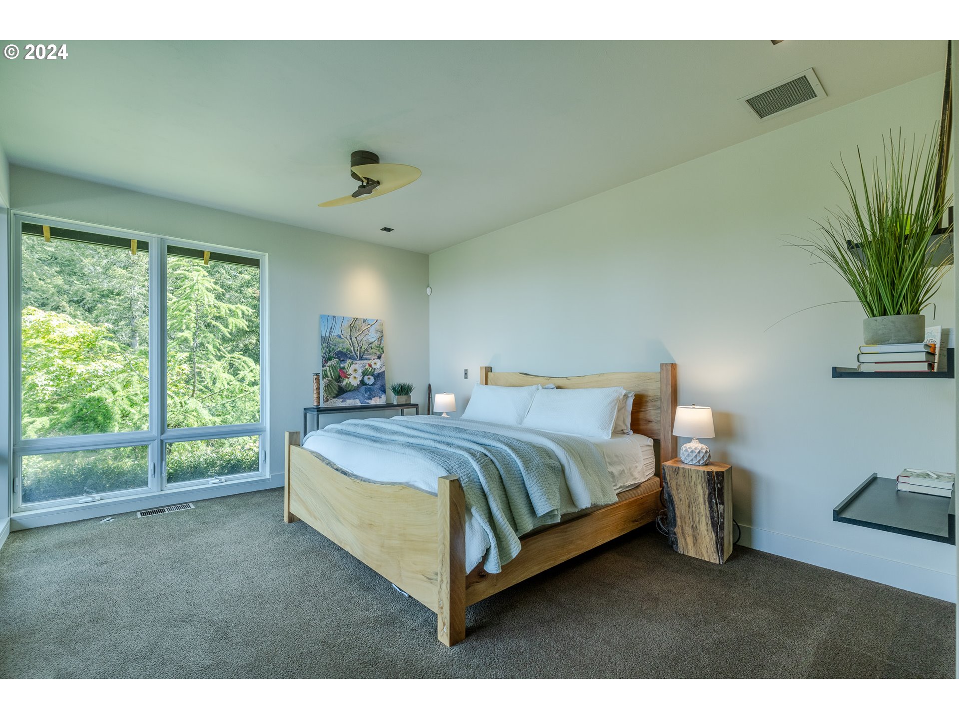 90535 Coburghills Drive Eugene, OR 97408 - Photo 22 of 48 a spacious bedroom with a bed window and potted plant