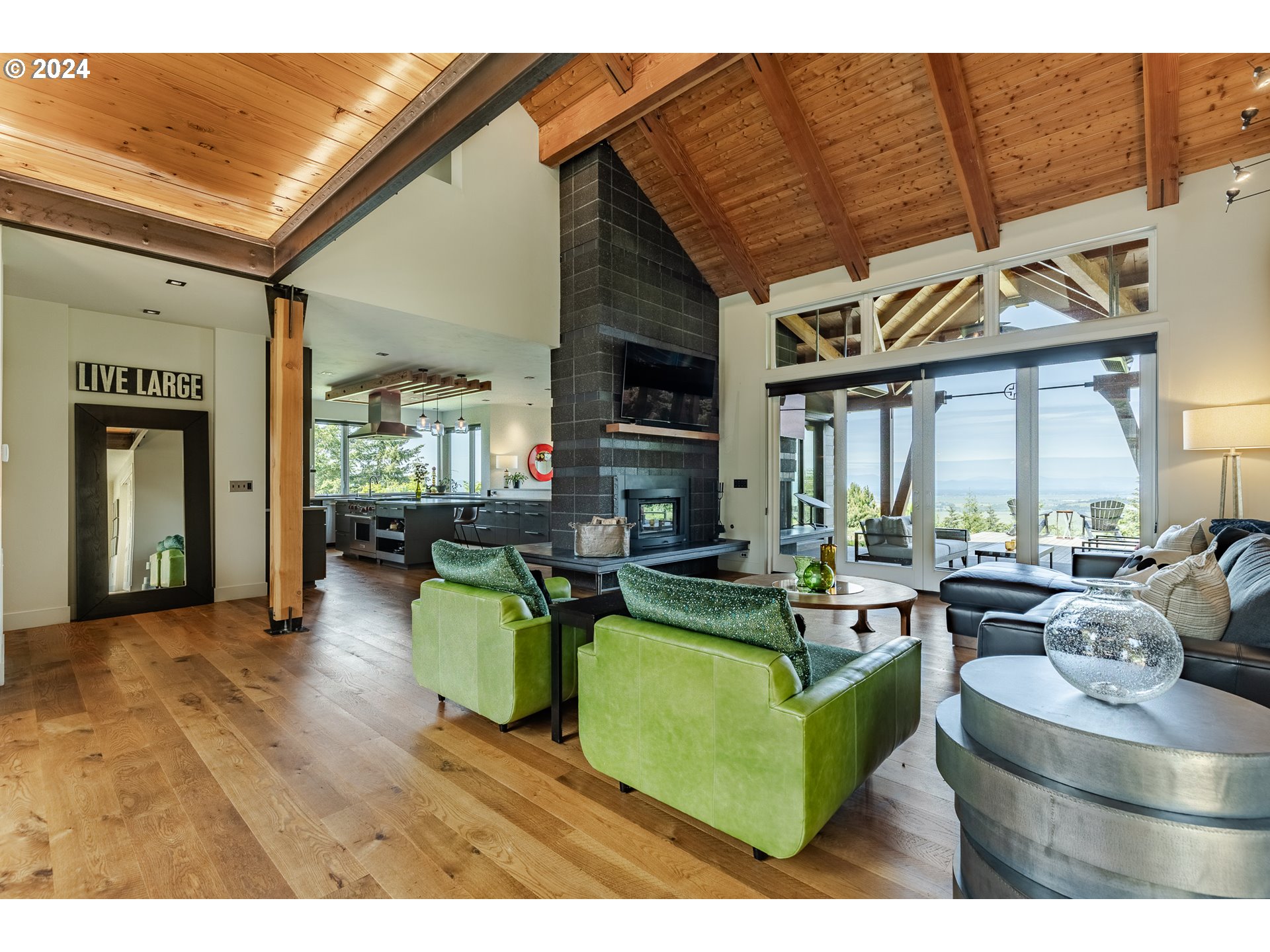 90535 Coburghills Drive Eugene, OR 97408 - Photo 10 of 48 a living room with furniture a large window and a fireplace