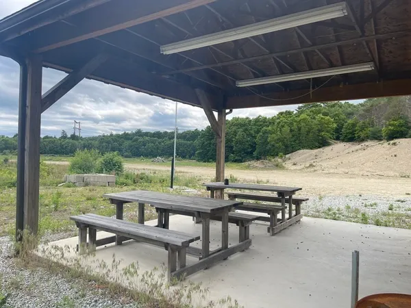 a view of a roof deck with couches and wooden floor