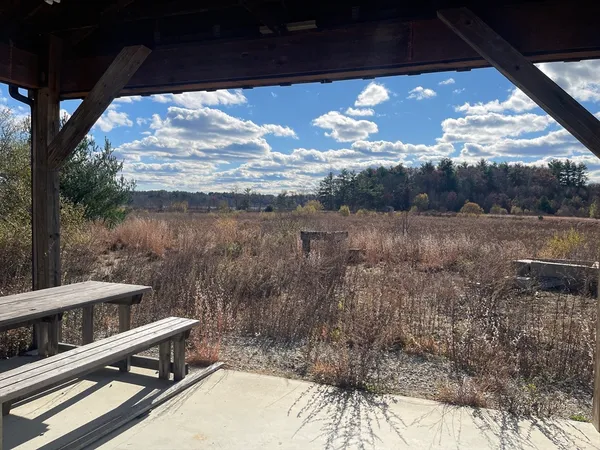 a view of a balcony with a yard