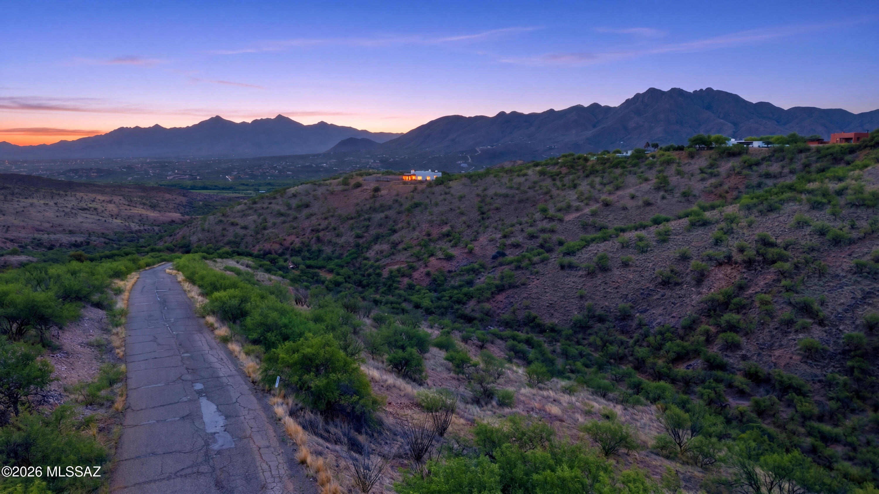 1544 Circulo Jacona, Unit 119 Rio Rico, AZ 85648 - Photo 2 of 16 a view of a lush green hillside and a houses