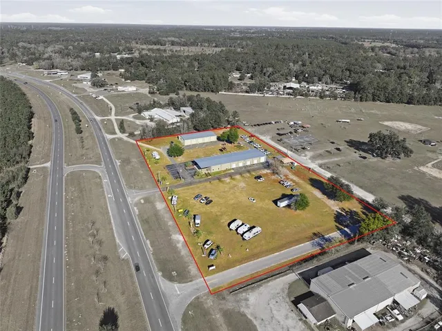 an aerial view of a residential houses with outdoor space