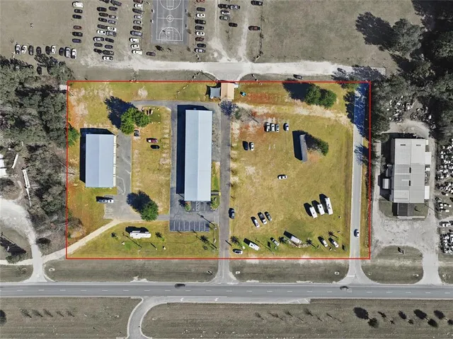 an aerial view of a swimming pool with a yard