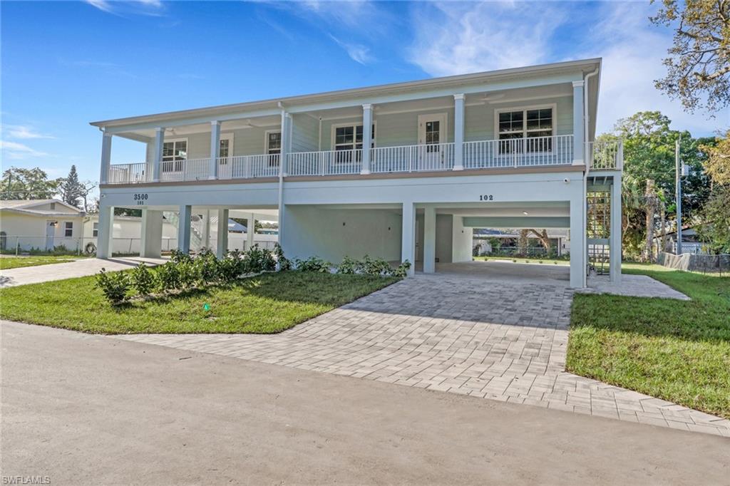 3500 Croton Road, Unit 102 Naples, FL 34104 - Photo 1 of 27 front view of a house with a yard