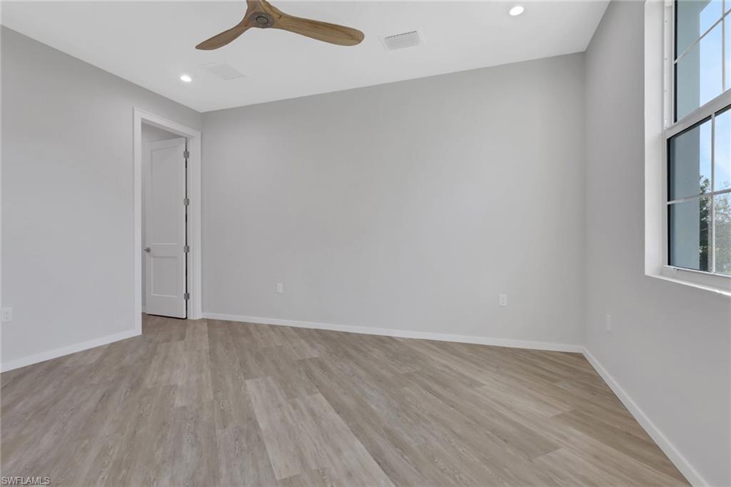 3500 Croton Road, Unit 102 Naples, FL 34104 - Photo 12 of 27 wooden floor in an empty room with a window