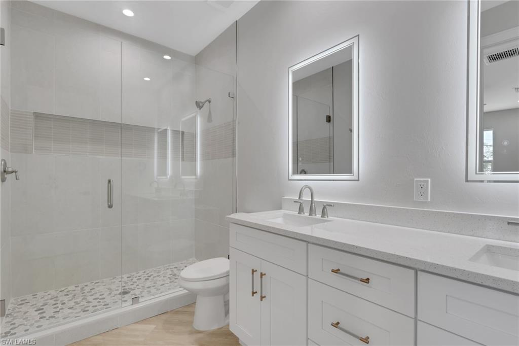 3500 Croton Road, Unit 102 Naples, FL 34104 - Photo 15 of 27 a bathroom with a sink a toilet and shower