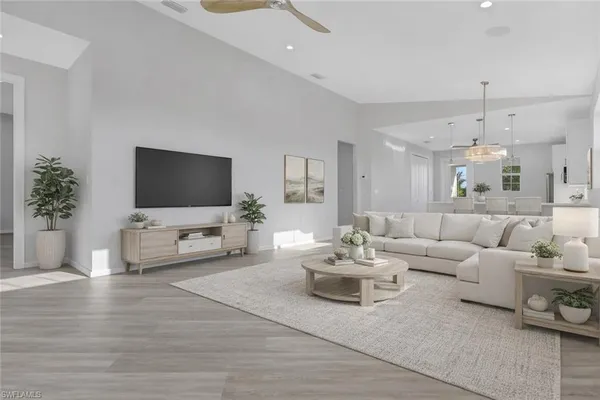 a living room with furniture and a flat screen tv