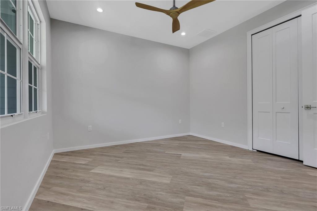 3500 Croton Road, Unit 102 Naples, FL 34104 - Photo 21 of 27 wooden floor in an empty room with a window