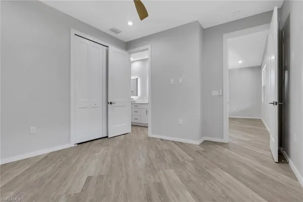 a view of wooden floor and windows in a room