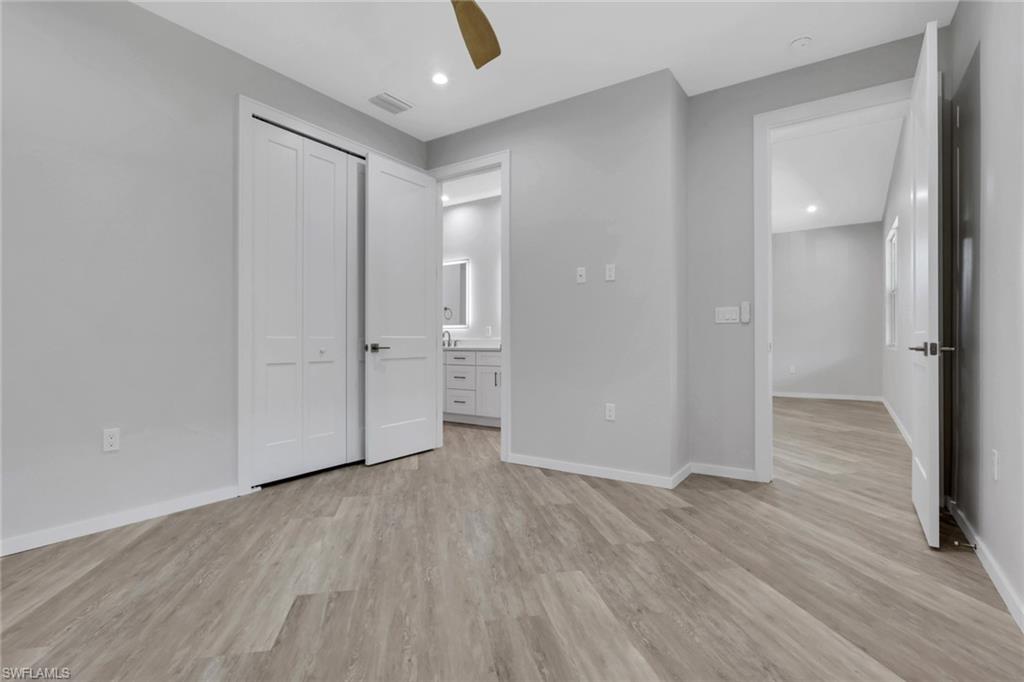 3500 Croton Road, Unit 102 Naples, FL 34104 - Photo 22 of 27 a view of wooden floor and windows in a room