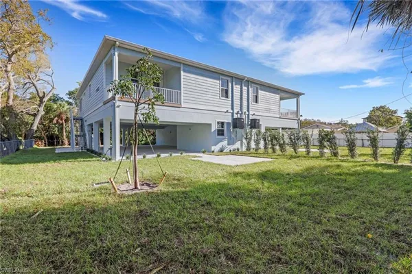 a view of house with backyard