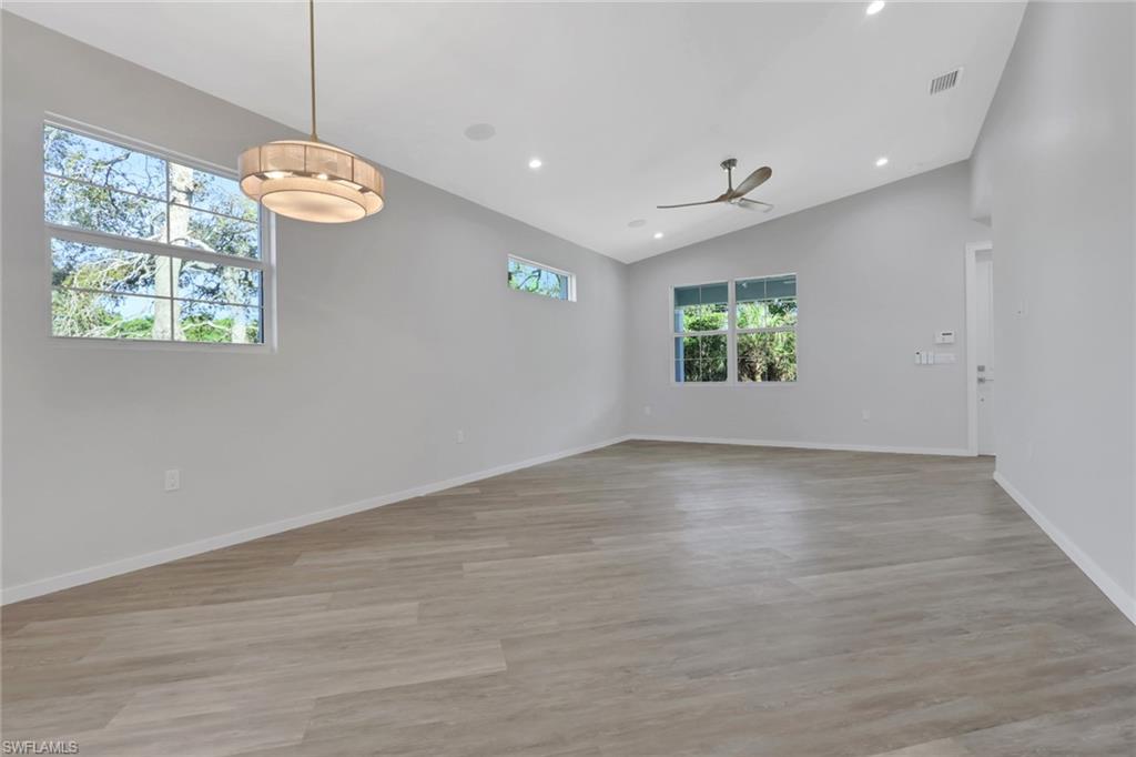 3500 Croton Road, Unit 102 Naples, FL 34104 - Photo 6 of 27 an empty room with windows and chandelier fan
