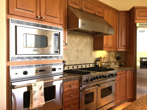 a stove top oven sitting inside of a kitchen