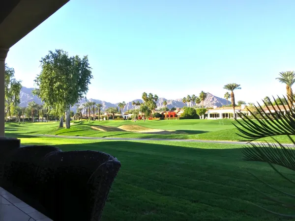 a view of building with outdoor space and trees in the background