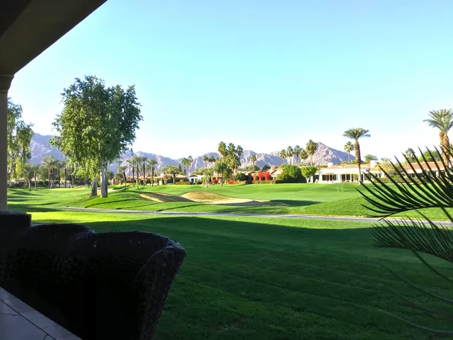 a view of building with outdoor space and trees in the background