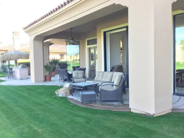 a view of a patio with table and chairs