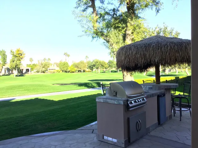 a backyard of a house with table and chairs