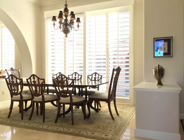 a view of a dining room with furniture and a chandelier