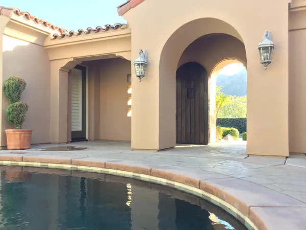 a view of a bedroom with a swimming pool and outdoor space