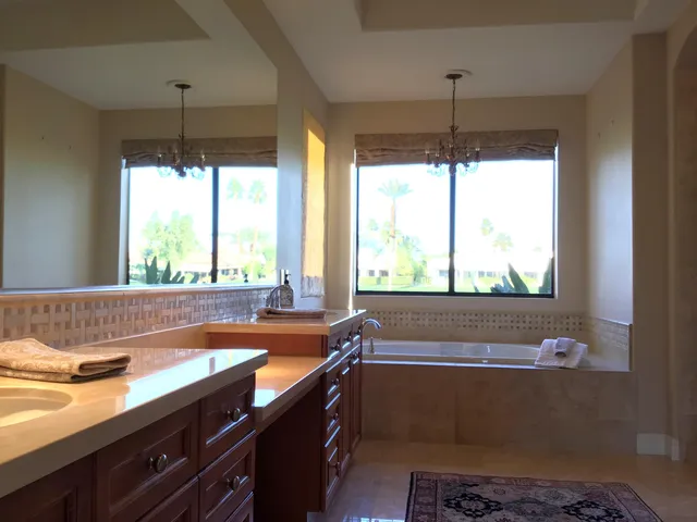 a bath room with a large window and a table