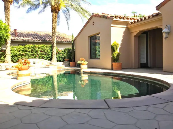 a view of a swimming pool with a lounge chair