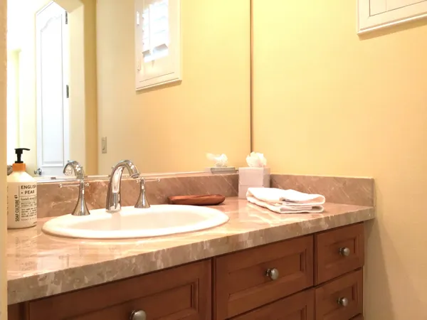 a bathroom with a double vanity sink and a mirror