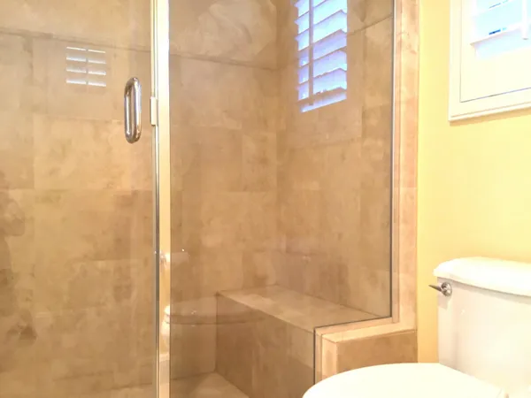 a bathroom with a toilet and shower