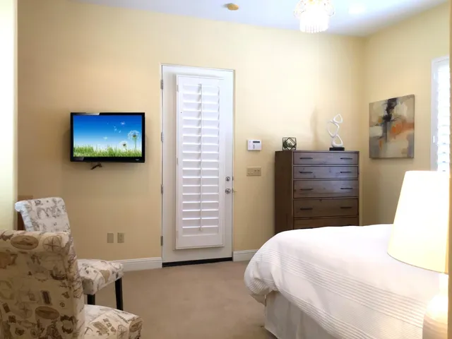 a bedroom with a bed and a flat screen tv