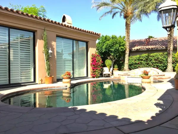 a swimming pool with outdoor seating and yard