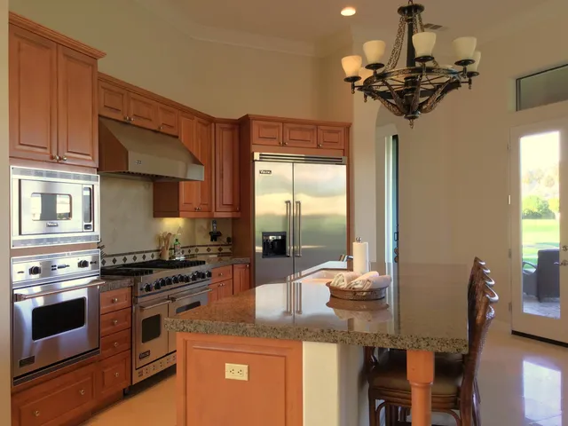 a kitchen with a counter space a sink and appliances