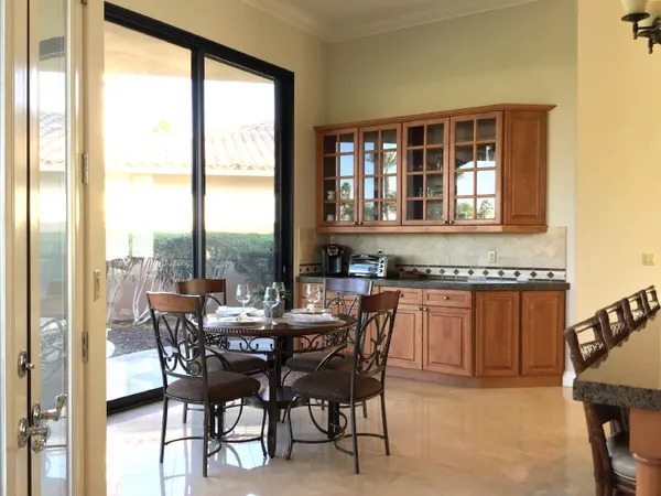 a view of a dining room with furniture and window