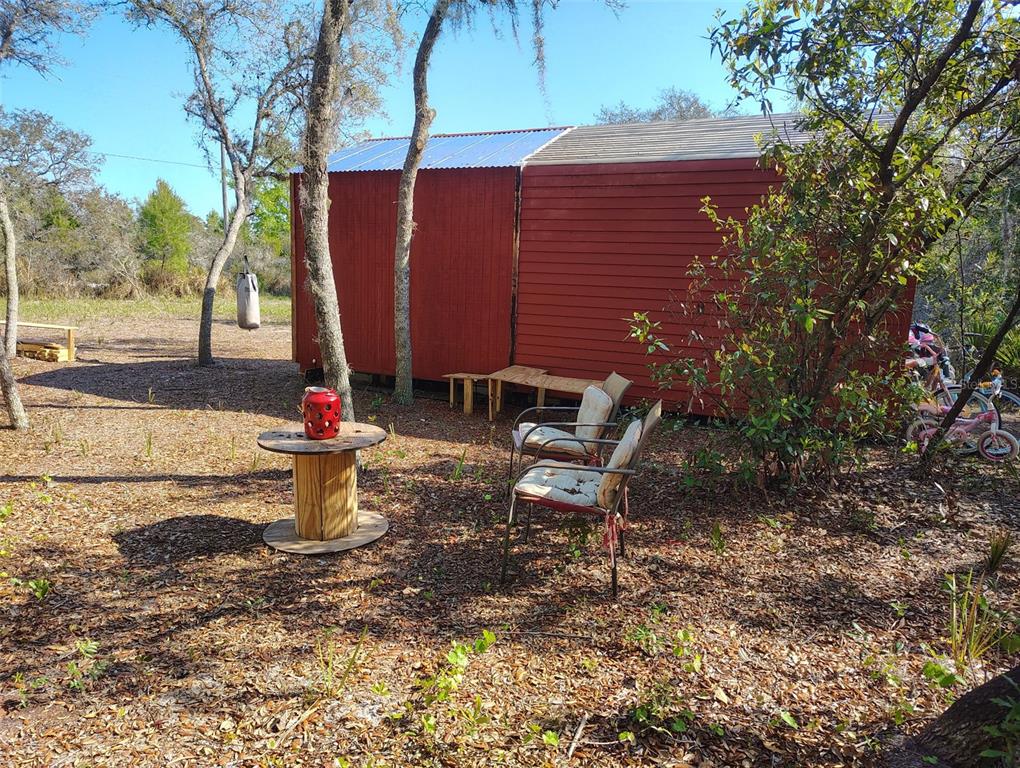1873 West Foxglove Road Avon Park, FL 33825 - Photo 3 of 14 a view of a chairs and table in backyard