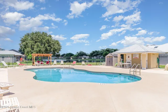 a view of a house with swimming pool and sitting area