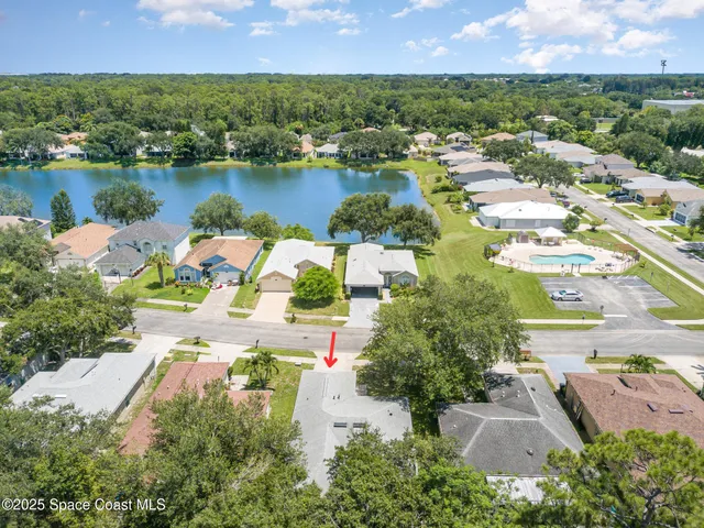 an aerial view of residential houses with outdoor space and river