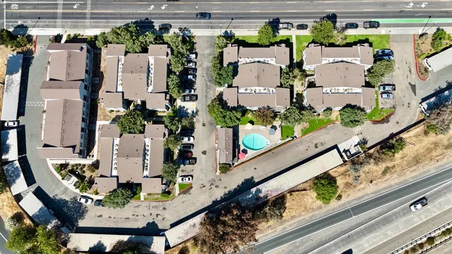 an aerial view of a house with outdoor seating