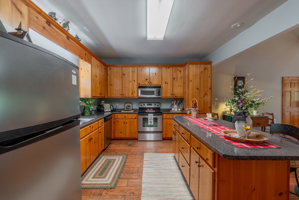 636 Kings Gap Road Hamilton, GA 31811 - Photo 14 of 63 a kitchen with kitchen island granite countertop a sink stove and cabinets
