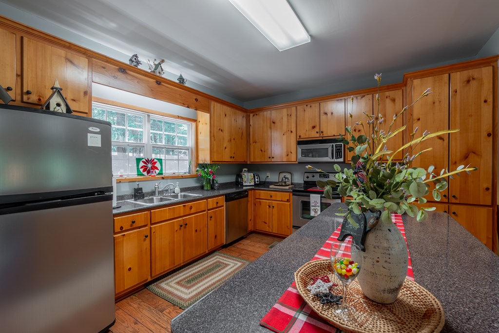 636 Kings Gap Road Hamilton, GA 31811 - Photo 15 of 63 a kitchen with granite countertop lots of wooden cabinetry and potted plants