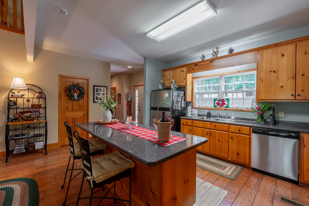 636 Kings Gap Road Hamilton, GA 31811 - Photo 16 of 63 a kitchen with stainless steel appliances kitchen island granite countertop a table chairs and a refrigerator
