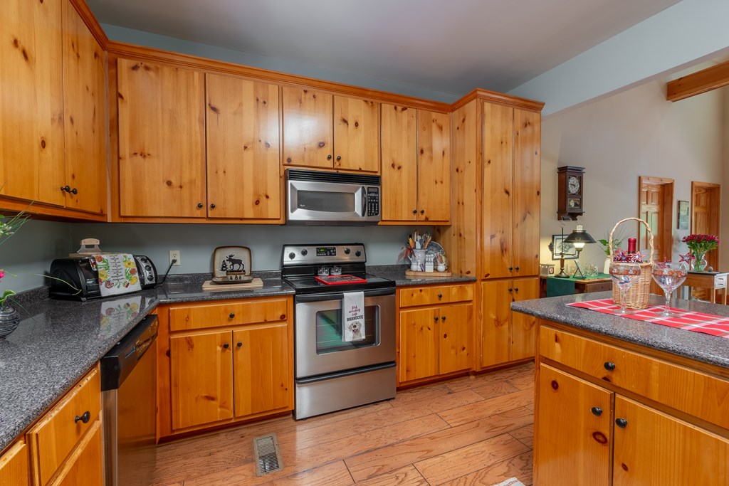 636 Kings Gap Road Hamilton, GA 31811 - Photo 19 of 63 a kitchen with stainless steel appliances granite countertop a stove sink and cabinets