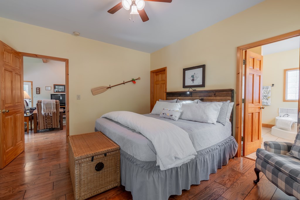 636 Kings Gap Road Hamilton, GA 31811 - Photo 24 of 63 a bedroom with a bed and a chandelier