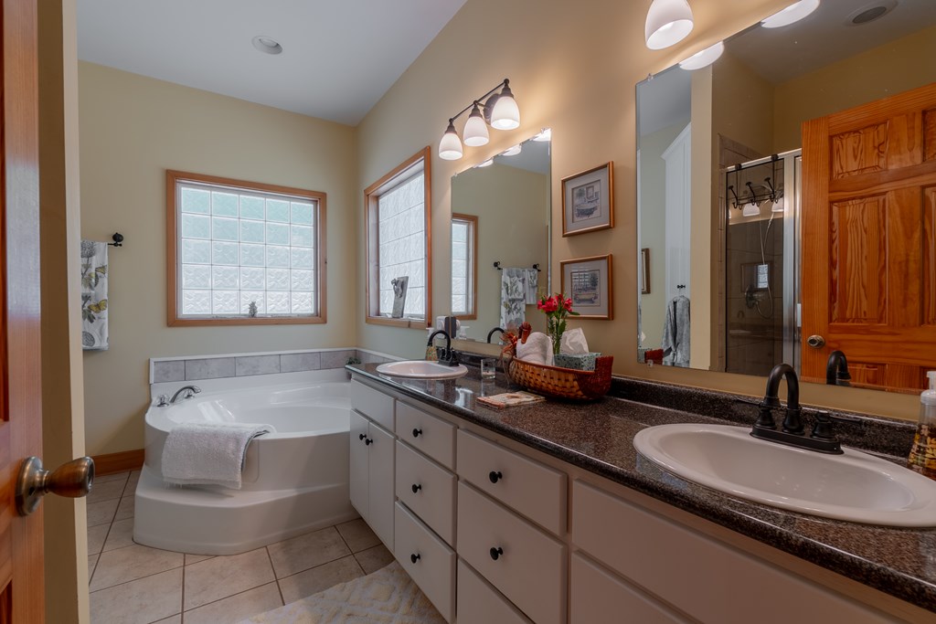 636 Kings Gap Road Hamilton, GA 31811 - Photo 25 of 63 a bathroom with a granite countertop sink a large mirror and a bathtub